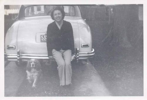 Ruth-Erdman-sitting-on-car-with-dog