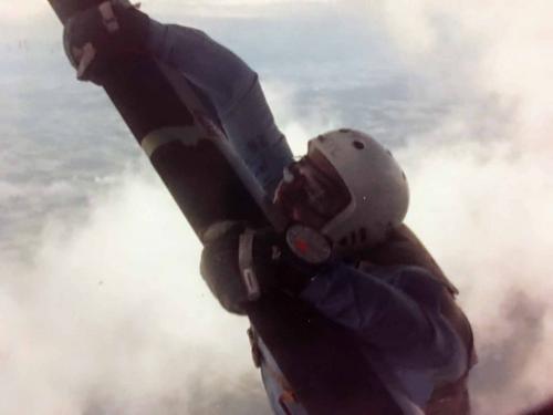 Climb out by keeping feet on step and sliding hands along strut out to the orange lines
